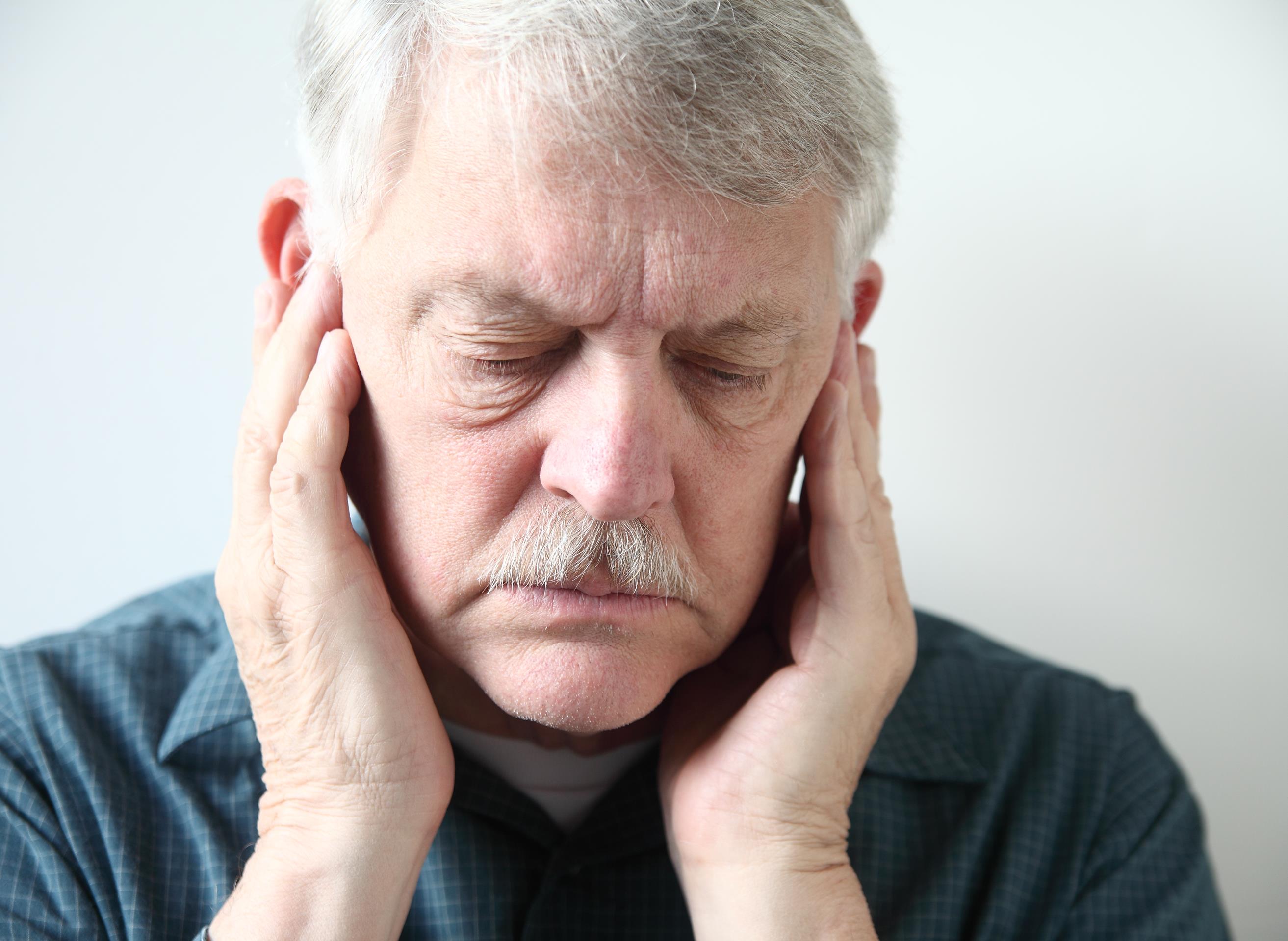Man experiencing jaw and head pain